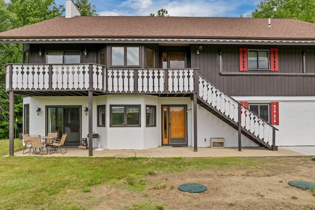 F22 Christmas Mountain Rd Unit 22, Bartlett, NH 03812 - back of property with stairway, roof with shingles, a patio, a yard, and a chimney