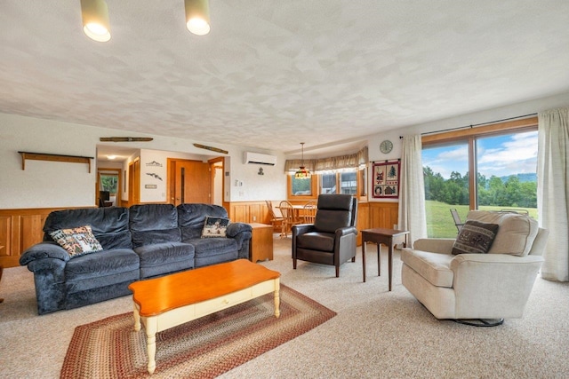 F22 Christmas Mountain Rd Unit 22, Bartlett, NH 03812 - carpeted living room featuring a wall mounted AC, a wainscoted wall, and a textured ceiling