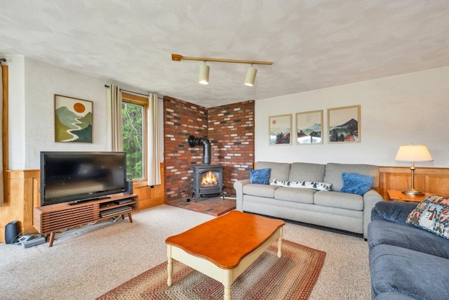 F22 Christmas Mountain Rd Unit 22, Bartlett, NH 03812 - carpeted living room with a wood stove, a textured ceiling, wainscoting, and wood walls