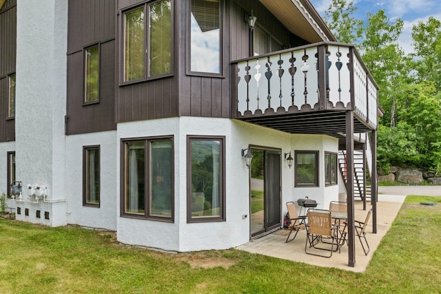 F22 Christmas Mountain Rd Unit 22, Bartlett, NH 03812 - rear view of property with a balcony, a patio area, and a lawn