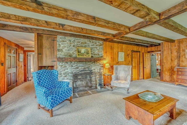 3247 Rte 302, Lisbon, NH 03585 - carpeted living room with wood walls, beamed ceiling, and a stone fireplace