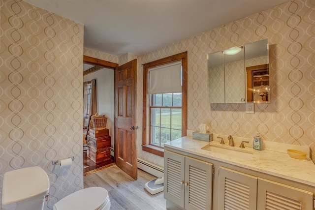 3247 Rte 302, Lisbon, NH 03585 - bathroom with wallpapered walls, wood finished floors, vanity, and a baseboard heating unit