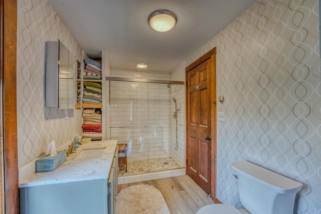 3247 Rte 302, Lisbon, NH 03585 - full bathroom featuring wood finished floors, vanity, a shower stall, and wallpapered walls