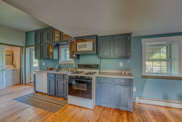 3247 Rte 302, Lisbon, NH 03585 - kitchen with white appliances, washer / clothes dryer, a baseboard heating unit, light countertops, and light wood finished floors