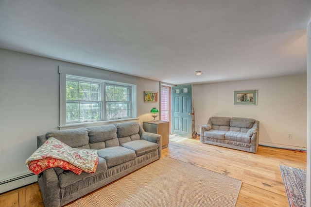3247 Rte 302, Lisbon, NH 03585 - living room with a baseboard heating unit and wood finished floors