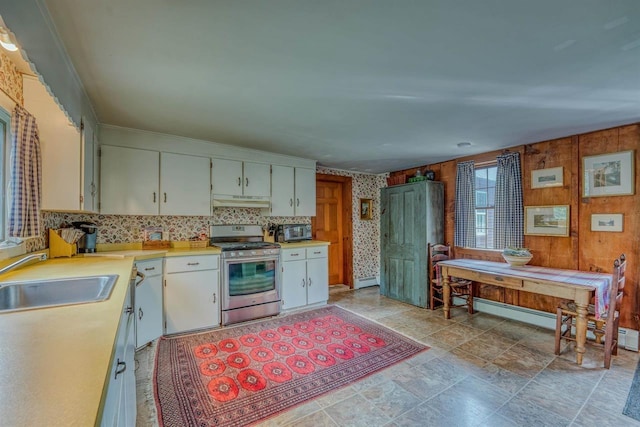 3247 Rte 302, Lisbon, NH 03585 - kitchen with stainless steel gas stove, light countertops, under cabinet range hood, black microwave, and tasteful backsplash