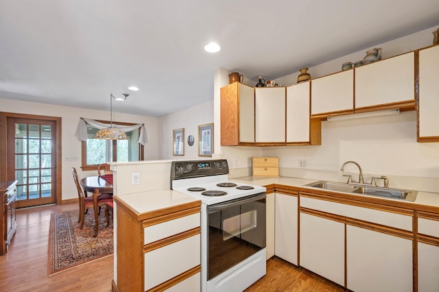 107 Peaked Hill Rd, Hopkinton, NH 03229 - kitchen with white range with electric cooktop, light countertops, light wood-type flooring, recessed lighting, and a peninsula
