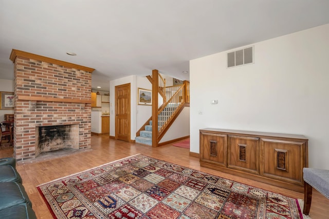 107 Peaked Hill Rd, Hopkinton, NH 03229 - unfurnished living room with wood finished floors, stairway, a fireplace, and recessed lighting