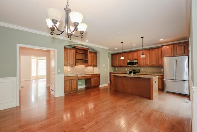 2C Manor Dr, Hooksett, NH 03106 - kitchen with stainless steel appliances, open shelves, brown cabinetry, a chandelier, and decorative backsplash