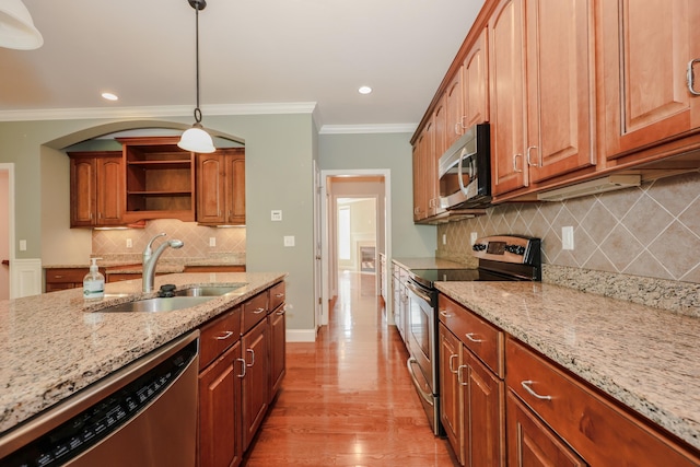 2C Manor Dr, Hooksett, NH 03106 - kitchen featuring appliances with stainless steel finishes, tasteful backsplash, open shelves, crown molding, and light stone countertops