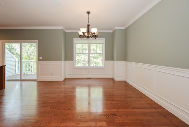 2C Manor Dr, Hooksett, NH 03106 - unfurnished room featuring a chandelier, plenty of natural light, wood finished floors, crown molding, and a wainscoted wall