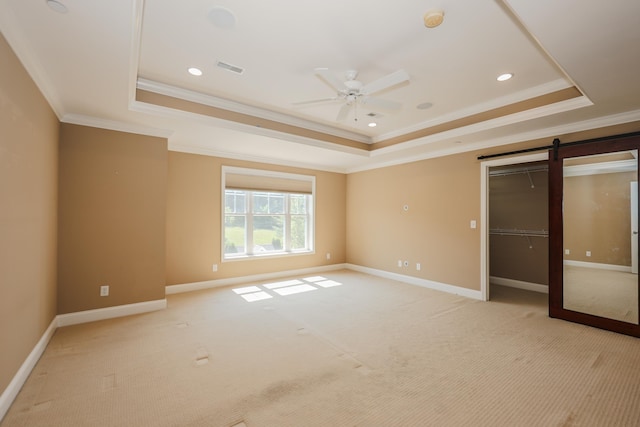 2C Manor Dr, Hooksett, NH 03106 - unfurnished bedroom with a tray ceiling, crown molding, a barn door, light carpet, and recessed lighting