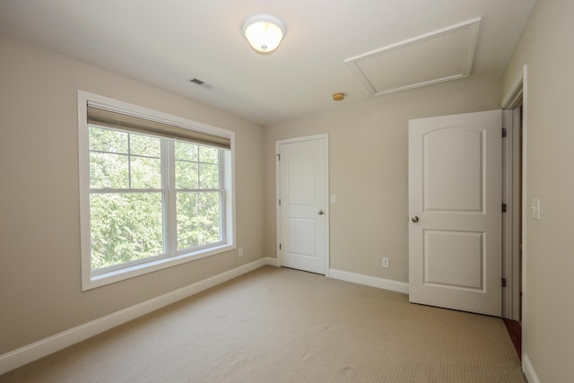 2C Manor Dr, Hooksett, NH 03106 - unfurnished bedroom featuring light colored carpet and attic access
