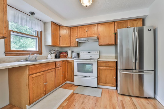 22 Pelham Rd, Hudson, NH 03051 - kitchen with freestanding refrigerator, under cabinet range hood, electric range, light countertops, and light wood-style flooring
