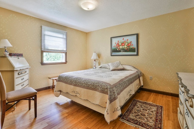 22 Pelham Rd, Hudson, NH 03051 - bedroom with light wood-type flooring and a textured ceiling