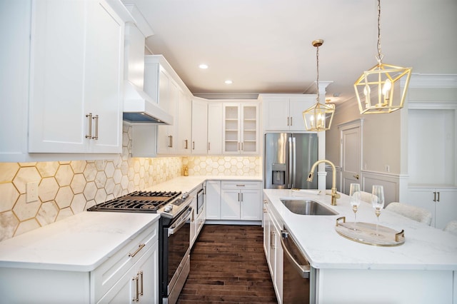50 Newfields Rd Unit A, Exeter, NH 03833 - kitchen featuring appliances with stainless steel finishes, wall chimney exhaust hood, dark wood-style floors, a center island with sink, and a chandelier