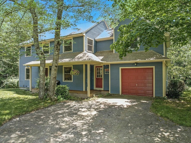 38 Cambridge Rd, Bedford, NH 03110 - view of front of property with driveway, covered porch, an attached garage, and a front lawn