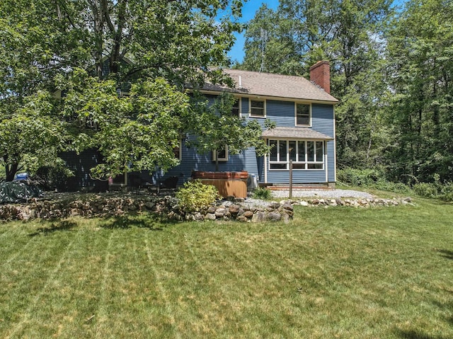 38 Cambridge Rd, Bedford, NH 03110 - view of front facade featuring a chimney, a front lawn, and a sunroom