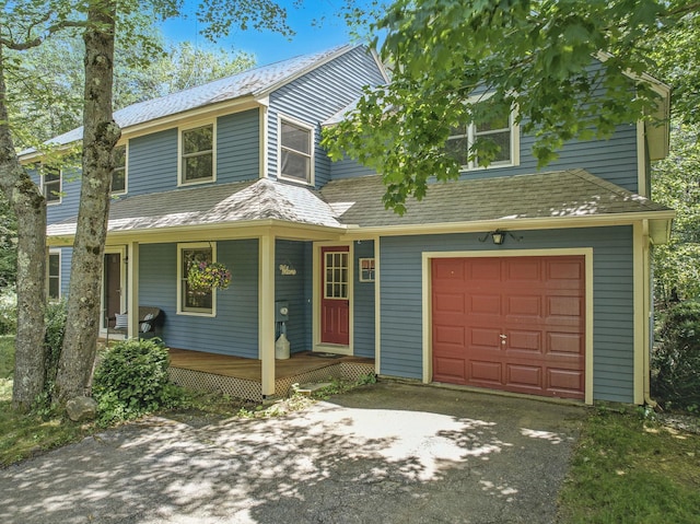 38 Cambridge Rd, Bedford, NH 03110 - view of front facade with driveway, a garage, a porch, and roof with shingles