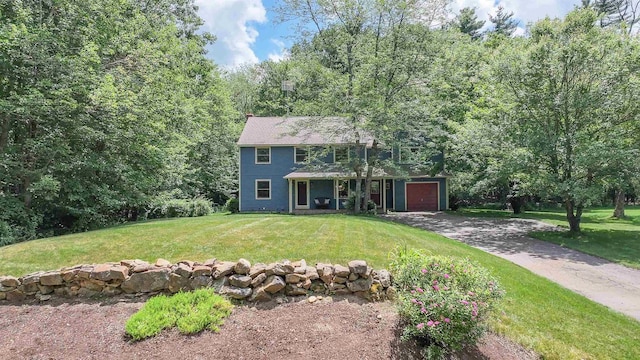38 Cambridge Rd, Bedford, NH 03110 - colonial-style house featuring asphalt driveway, a front lawn, and a garage