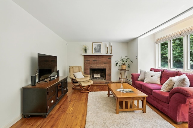 38 Cambridge Rd, Bedford, NH 03110 - living area featuring a brick fireplace and light wood finished floors