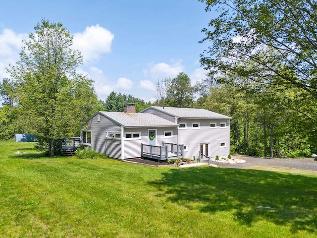 626 County Rd, New London, NH 03257 - rear view of house featuring a deck, a chimney, and a lawn