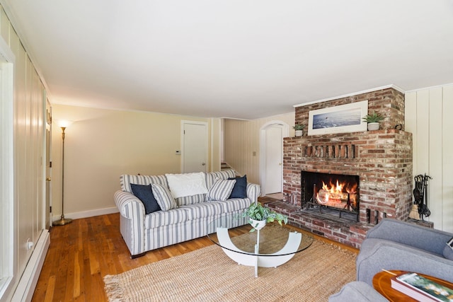 626 County Rd, New London, NH 03257 - living room featuring baseboard heating, wood finished floors, and a fireplace