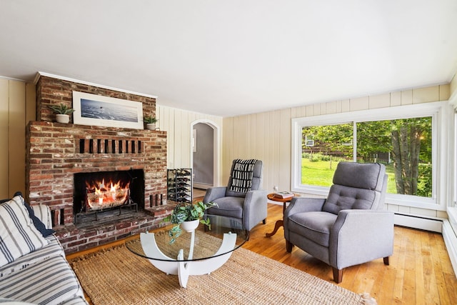 626 County Rd, New London, NH 03257 - living area featuring light wood-style flooring, a fireplace, and arched walkways