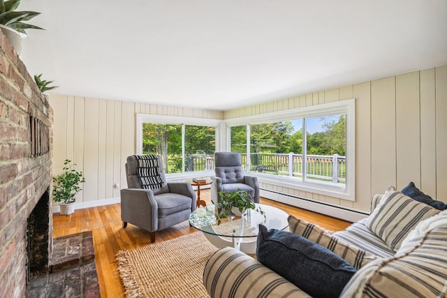 626 County Rd, New London, NH 03257 - living room with a baseboard heating unit, plenty of natural light, a fireplace, and hardwood / wood-style flooring