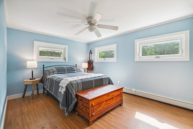 626 County Rd, New London, NH 03257 - bedroom with a baseboard heating unit, wood finished floors, and ceiling fan