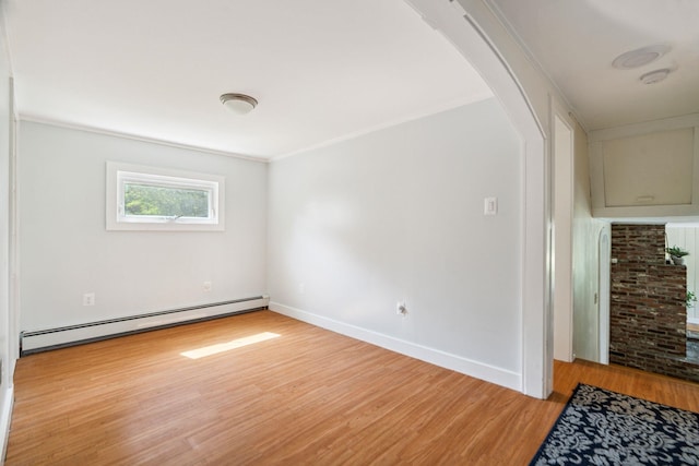 626 County Rd, New London, NH 03257 - empty room with a baseboard radiator, arched walkways, light wood-type flooring, and a smoke detector