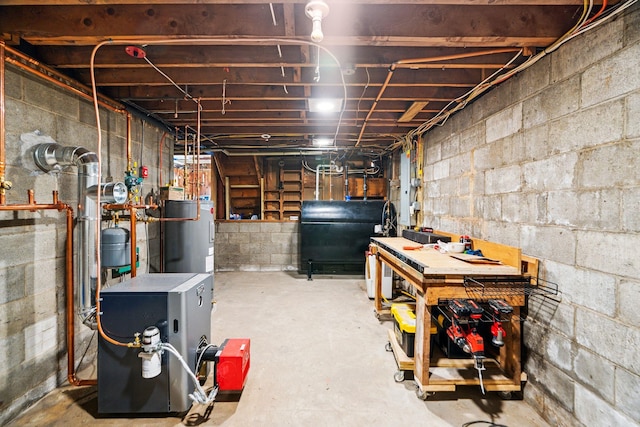 626 County Rd, New London, NH 03257 - unfinished below grade area featuring heating fuel, a heating unit, a workshop area, and water heater