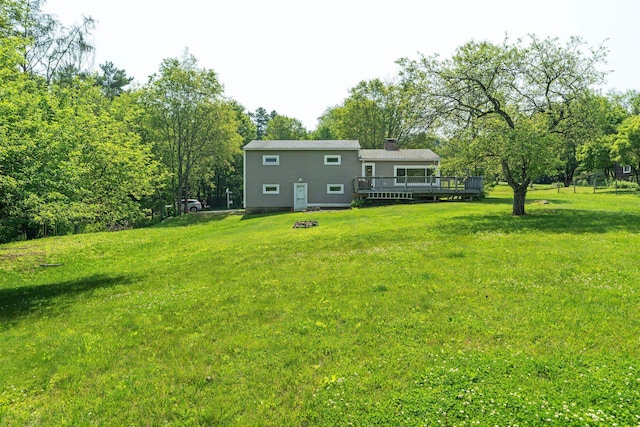 626 County Rd, New London, NH 03257 - rear view of house featuring a deck, a lawn, and a chimney