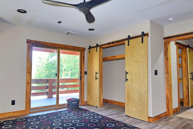 00 Serenity Ln, Lisbon, NH 03585 - doorway with a barn door, light wood finished floors, and ceiling fan