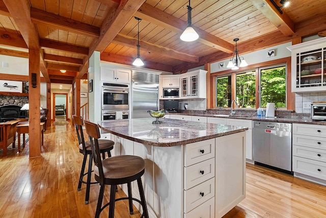 82 Little Cove Rd, New London, NH 03257 - kitchen featuring built in appliances, a wooden ceiling with exposed beams, light wood-style floors, decorative backsplash, and white cabinets
