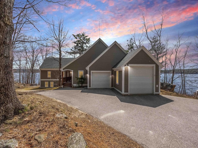 432 Shore Dr, Laconia, NH 03246 - view of front of property with an attached garage, driveway, and a water view
