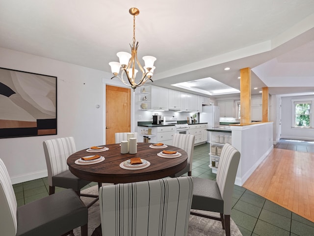 432 Shore Dr, Laconia, NH 03246 - dining area featuring a tray ceiling, a chandelier, light tile patterned flooring, and recessed lighting