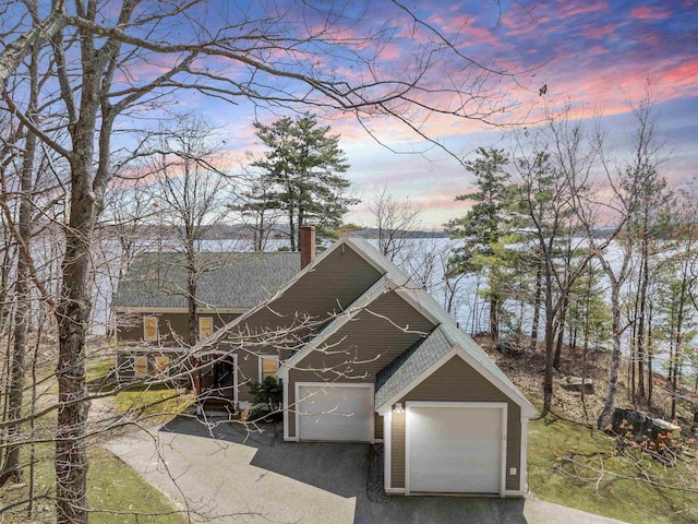 432 Shore Dr, Laconia, NH 03246 - view of front facade featuring a chimney and roof with shingles