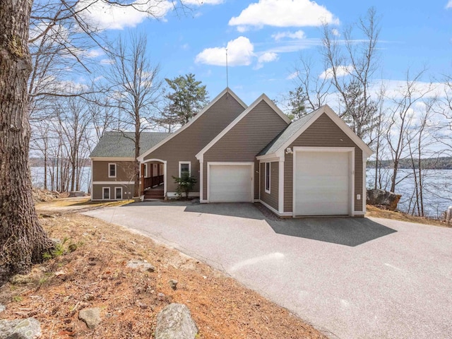 432 Shore Dr, Laconia, NH 03246 - view of front of house with an attached garage, asphalt driveway, and roof with shingles