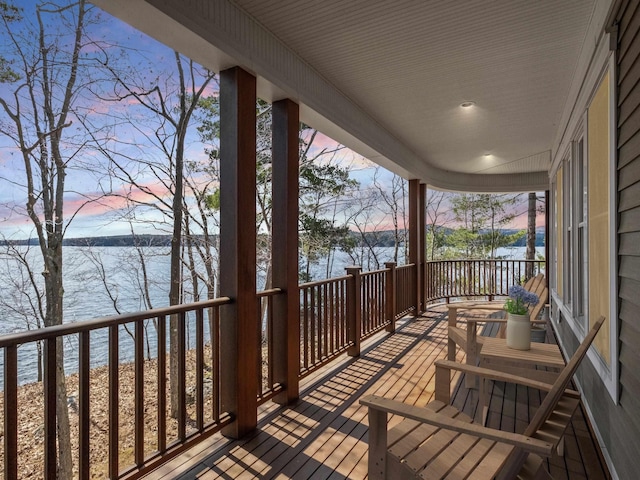 432 Shore Dr, Laconia, NH 03246 - deck at dusk with a water view