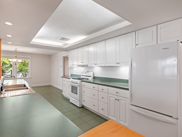 432 Shore Dr, Laconia, NH 03246 - kitchen with white appliances, a tray ceiling, white cabinetry, and recessed lighting