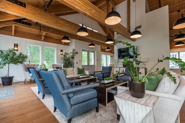 32 Willey Creek Rd Unit 402, Exeter, NH 03833 - living room with high vaulted ceiling, wood finished floors, and beam ceiling