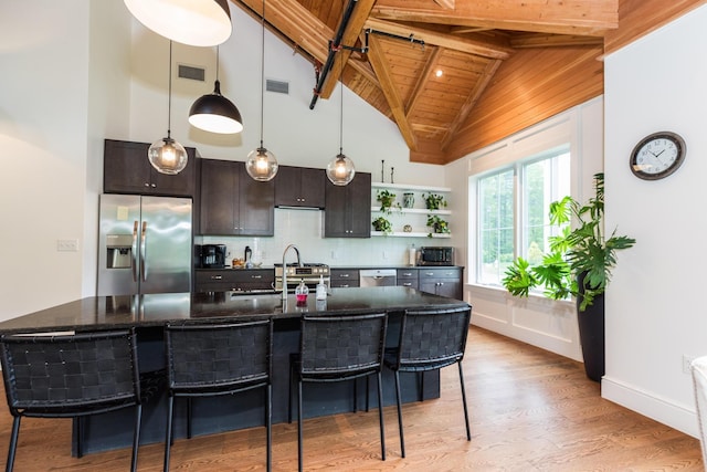 32 Willey Creek Rd Unit 402, Exeter, NH 03833 - kitchen featuring appliances with stainless steel finishes, open shelves, a wooden ceiling with exposed beams, a kitchen bar, and light wood-style floors