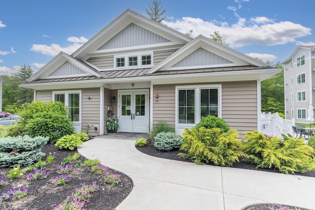 32 Willey Creek Rd Unit 402, Exeter, NH 03833 - view of front facade featuring a standing seam roof, board and batten siding, a metal roof, and french doors