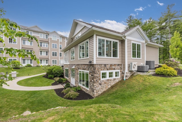 32 Willey Creek Rd Unit 402, Exeter, NH 03833 - view of home's exterior featuring a yard and stone siding