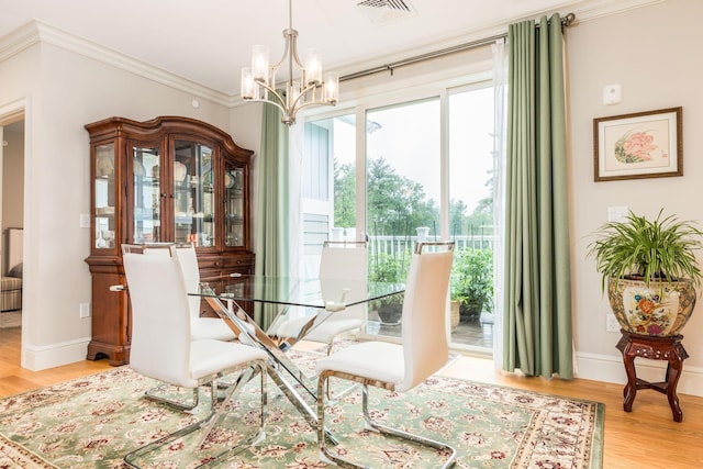 32 Willey Creek Rd Unit 402, Exeter, NH 03833 - dining space with a chandelier, wood finished floors, and ornamental molding