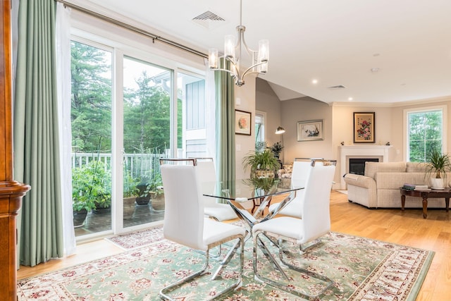 32 Willey Creek Rd Unit 402, Exeter, NH 03833 - dining space featuring a chandelier, light wood finished floors, a fireplace, and recessed lighting