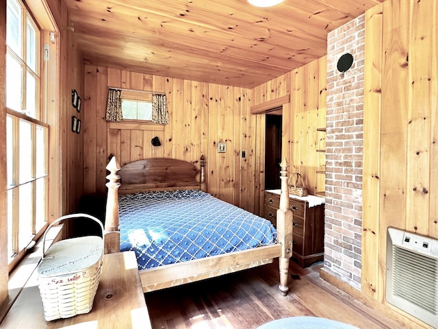 32 Pikes Point Rd, Bristol, NH 03222 - bedroom featuring wooden ceiling, wood finished floors, wooden walls, and heating unit
