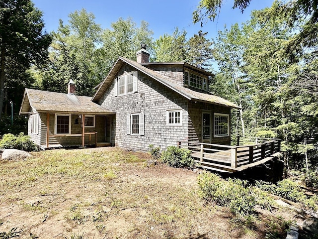 32 Pikes Point Rd, Bristol, NH 03222 - rear view of house featuring a chimney and a wooden deck