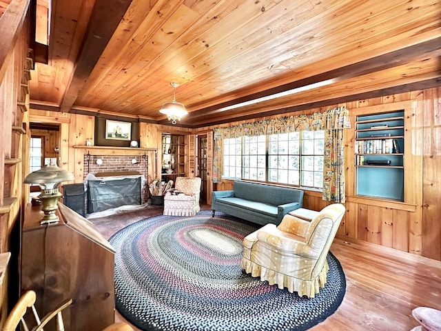 32 Pikes Point Rd, Bristol, NH 03222 - living area featuring wooden walls, wooden ceiling, wood finished floors, and a fireplace